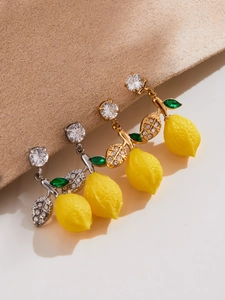 Détail de boucles d'oreilles citron avec zircons 5A et feuilles vertes en or et argent