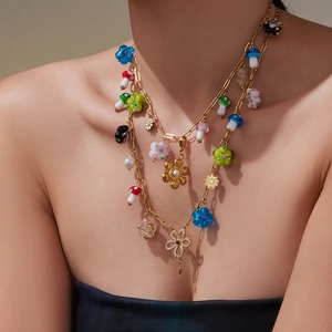 Gold layered necklace featuring colorful resin mushrooms and floral charms for women