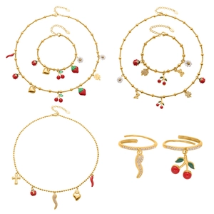 Golden stainless steel jewelry set featuring colorful enamel fruit and floral charms