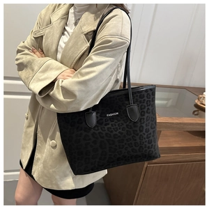 Detail view of leopard print tote bag with FASHION lettering and shoulder strap