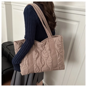 Macro detail of the wavy quilted stitching on this large capacity padded tote bag