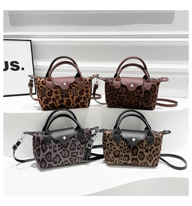 Detailed close-up of leopard print handbags in four colors with leather flaps and straps