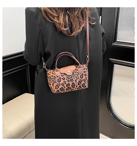 Detail of leopard print and rose pattern texture on a vintage French shoulder bag