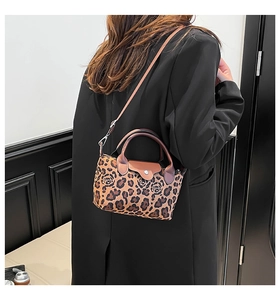 Detail of small leopard and rose print handbag styled with a black oversized blazer