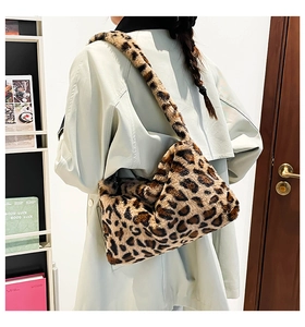 Close-up of fluffy faux fur shoulder bag with vintage leopard print and plush texture