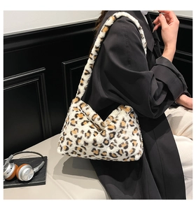 Detail of soft leopard print faux fur shoulder bag worn with a black wool coat