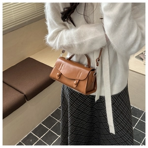 Brown vintage faux leather baguette bag shown with a winter knit sweater outfit