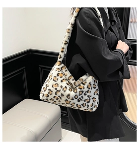 Close-up of fluffy leopard print plush shoulder bag texture and cozy material details
