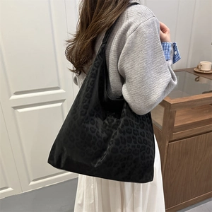 Retro leopard print tote bag in dark matte finish styled with minimalist casual outfit