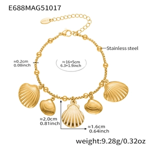 Detail of stainless steel bead chain bracelet featuring multiple gold shell pendants