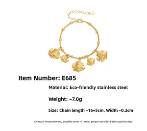 Detailed view of gold stainless steel bracelet featuring five engraved fish charms