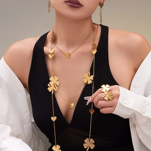 Gold stainless steel jewelry set featuring layered heart and clover necklaces with matching ring