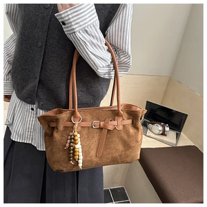 Detail of dark brown faux suede retro shoulder bag with decorative colorful wood beads