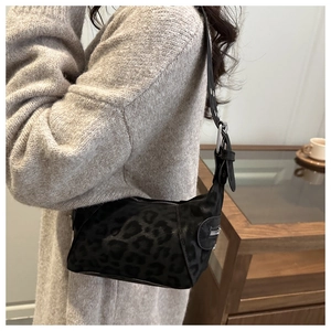 Detail of leopard print shoulder bag with metallic buckle and side zipper accents