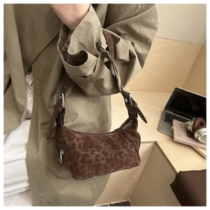 Detail of vintage leopard print suede tote with silver zipper and leather shoulder strap