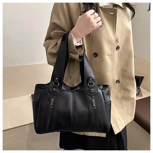Close-up of black PU leather tote bag with lychee texture and dual zipper detail