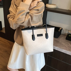 Cream white embossed tote bag with black handles and cute cartoon pattern designs