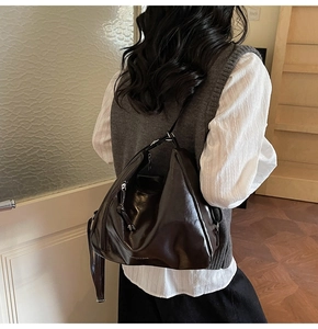 Detailed view of the large vintage dark coffee hobo bag showing texture and leather drape