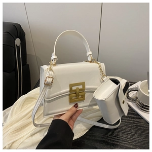 White leather shoulder bag with gold geometric clasp and mini hanging pouch on chain