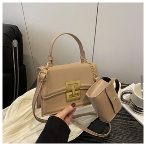 Detail of beige crossbody bag with gold square buckle and small round coin purse
