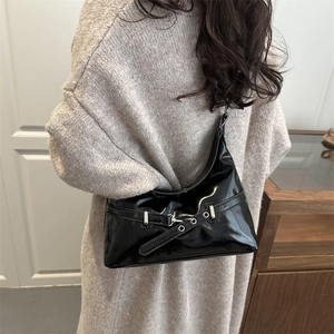 Minimalist black patent leather underarm bag with metal buckle and stylish strap detail