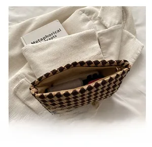 Macro view of houndstock pattern fabric on large capacity cosmetic pouch with zipper