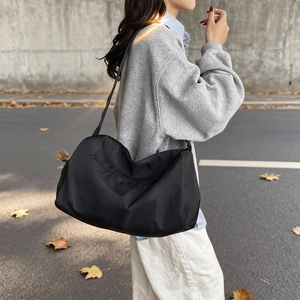 Large black waterproof nylon duffel bag for fitness and travel with zip closure