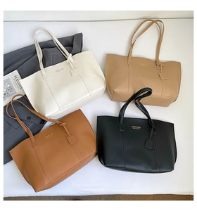 Flat lay of minimalist leather tote bags in white, beige, brown, and black colors