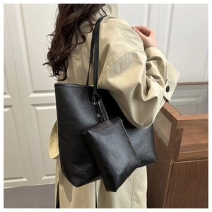 Detail of black tote bag set with matching inner pouch on model, stylish commuters style