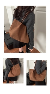 Close-up of brown suede tote bag showing large capacity and soft texture on shoulder