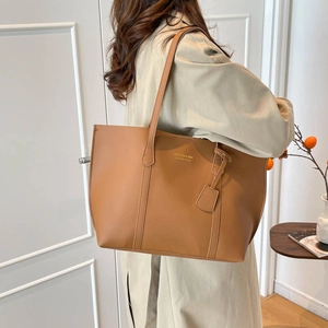 Minimalist brown large capacity tote bag with adjustable shoulder strap and leather texture