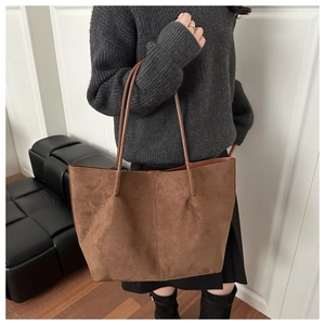 Close-up of vintage brown suede tote bag featuring high capacity and minimalist texture