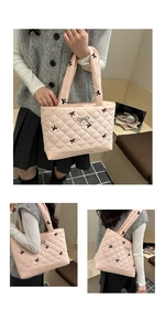 Dettaglio borsa shopper rosa trapuntata con ricami di fiocchi neri e chiusura in metallo