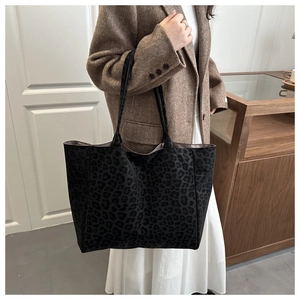 Detailed view of the large leopard print tote bag with thick textured fabric and shoulder strap