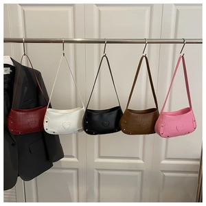 Detail of rivet-decorated crocodile pattern shoulder bags in five classic colors