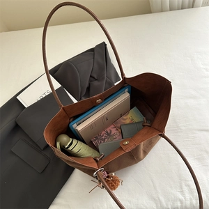 Brown faux suede tote bag with large capacity showing books and tablet inside