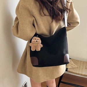 Grand sac cabas en toile noire avec garniture en cuir marron et breloque ourson à l'épaule