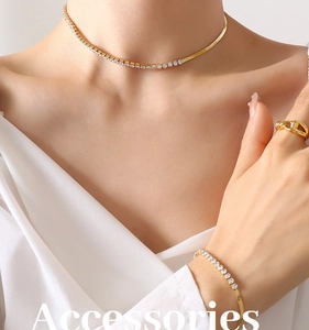 Detail of gold-plated blade chain necklace and bracelet set with sparkling cubic zirconia