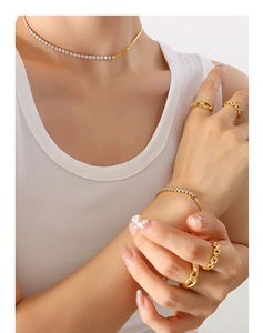Detail of gold-plated choker and bracelet set with sparkling zircon crystal inlays