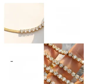 Detail of 18K gold plated titanium blade chain necklace with zircon stones in soft light