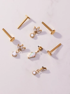 Detailed set of gold titanium labret piercings with opal and marquise zircon charms