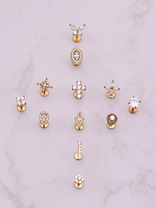 Collection of gold piercing studs featuring butterfly and star designs with clear zircon stones