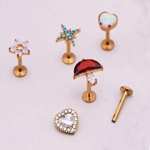 Titanium piercing jewelry set with gold finish and colorful gemstone flower designs