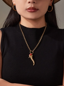 Close-up of 18k gold plated stainless steel chili pendant necklace and twisted hoop earrings