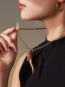 Detail of 18k gold chili pepper pendant with red ladybug detail on classic link chain