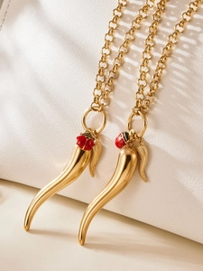 Detail of 18k gold plated stainless steel chili pendant with ladybug and feather charms
