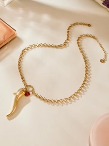 Detail of 18k gold plated chili horn pendant with red ladybug and S.STEEL engraving