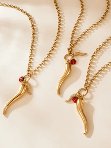 Detail of 18k gold plated stainless steel chili horn and ladybug pendant necklaces