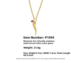 Detail of gold chili pendant with red enamel flower and white zircon on stainless chain