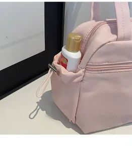 Detail of the pink canvas tote bag side pocket with adjustable drawstring and bottle